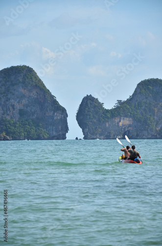 Thai people and foreign travelers rowing canoe kayak in sea for relax travel visit limestone isle mountain in ocean of andaman near Railay island in Ao Nang bay of Krabi province southern of Thailand