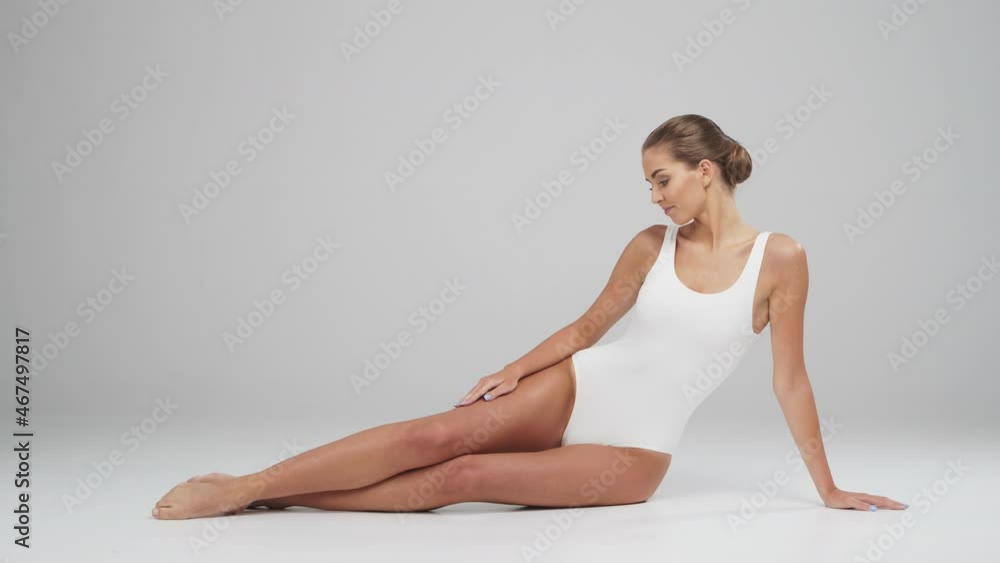 Young, beautiful, fit and natural blond woman in white swimsuit. Epilation, skin care, cellulite removal, and weight loss. Young, beautiful, fit and natural blond woman in white swimsuit. Epilation, skin care, cellulite removal, and weight loss.
