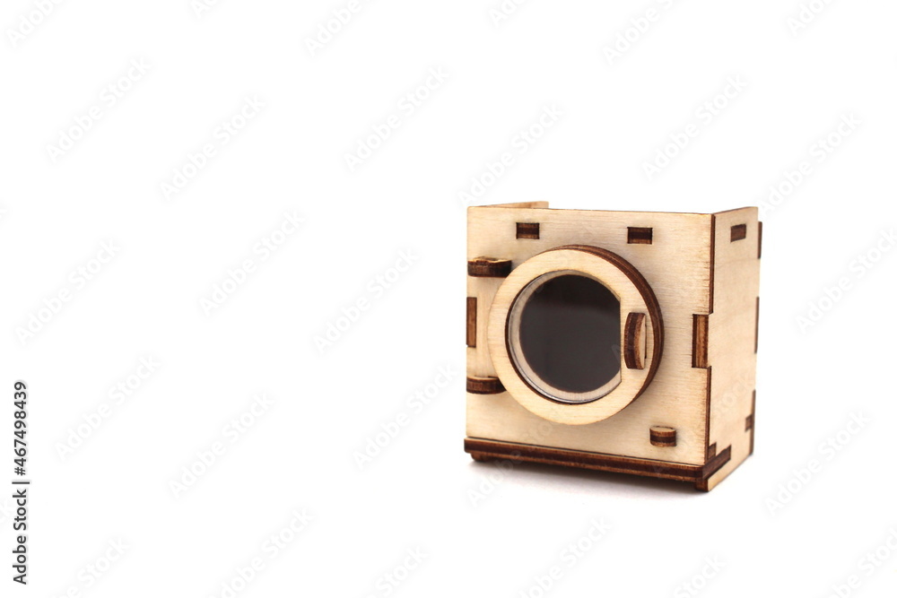 Wooden children`s toy washing machine assembled from plywood on a white isolated background Wooden children`s toy washing machine assembled from plywood on a white isolated background