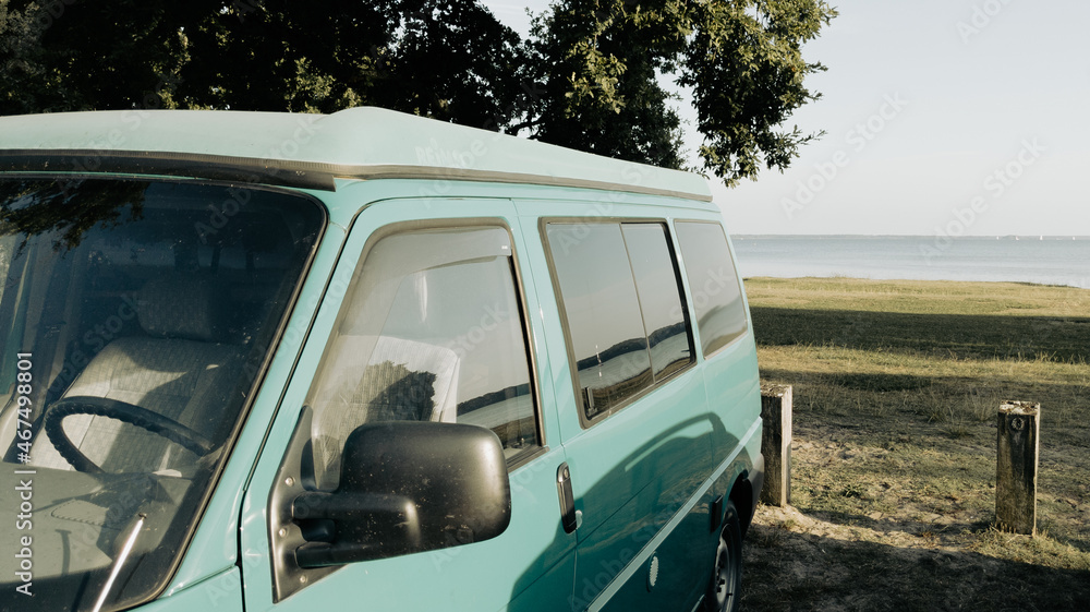 camper Motorhome RV campervan parked on lake side beach for night