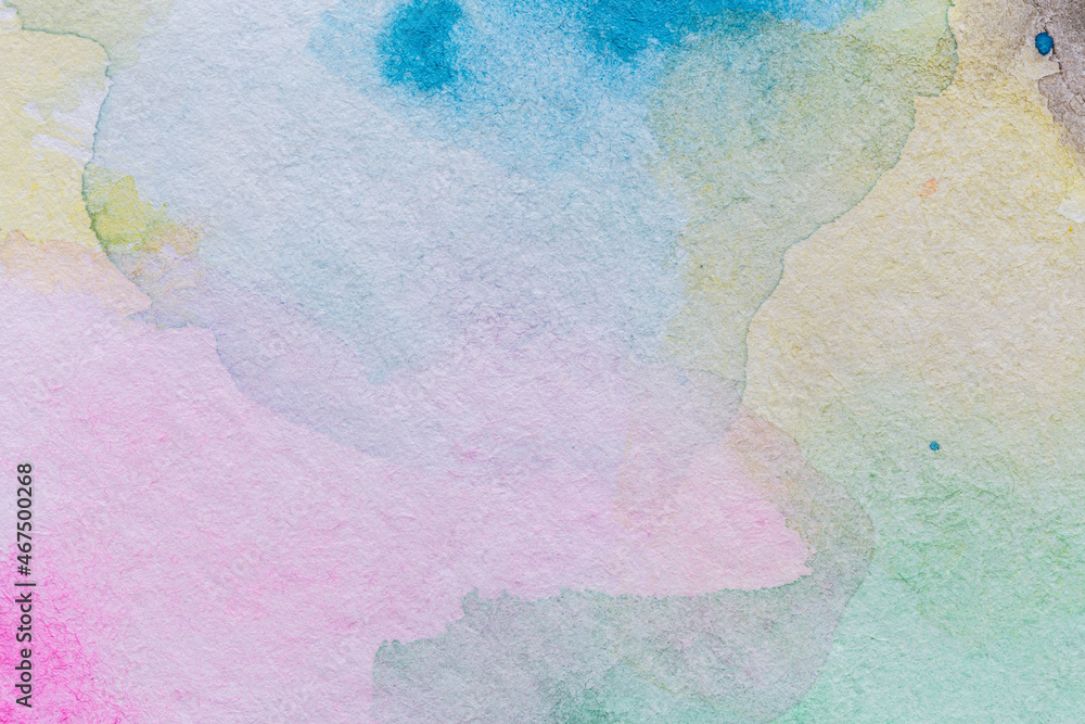 Macro close-up of an abstract multicolored yet pale watercolor gradient fill background with watercolour stains. High resolution full frame textured white paper background.