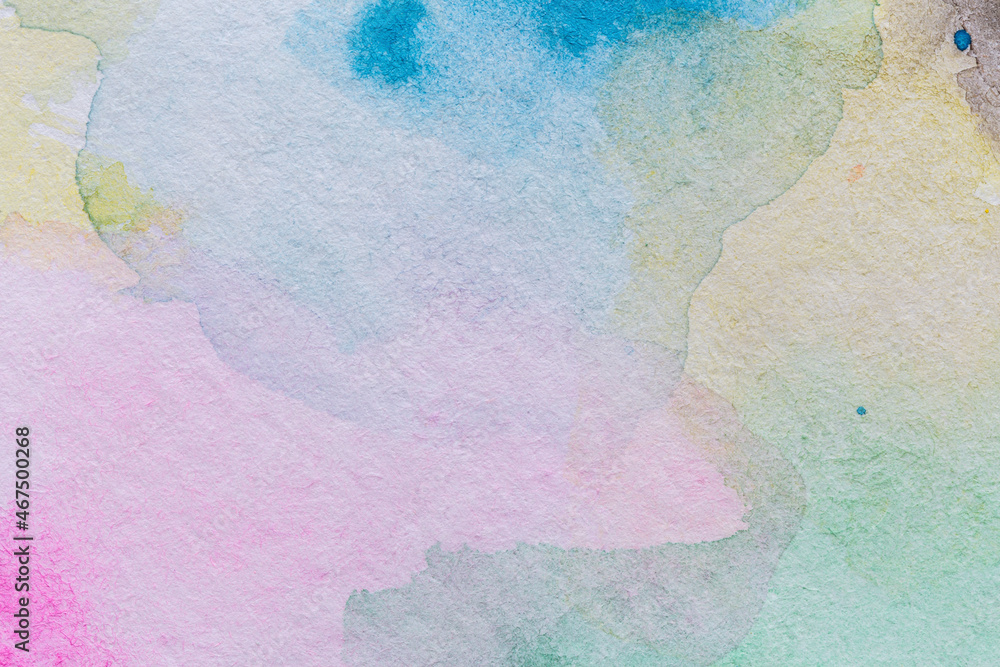 Fototapeta premium Macro close-up of an abstract multicolored yet pale watercolor gradient fill background with watercolour stains. High resolution full frame textured white paper background.