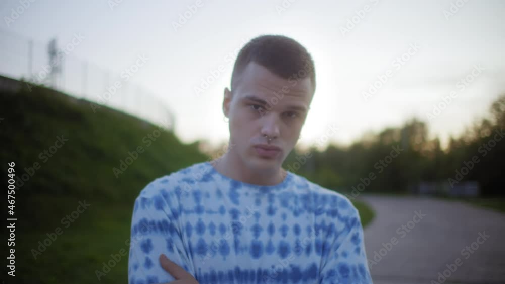 Close up portrait of a young man with sunglasses and piercing or nose ring, brutal punk male, generation z lifestyle. Student alternative boy. Hipster Millennial Close up portrait of a young man with sunglasses and piercing or nose ring, brutal punk male, generation z lifestyle. Student alternative boy. Hipster Millennial