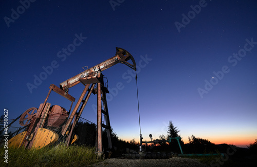Canvas Print Beautiful panoramic view of night oil filed with petroleum pump jack