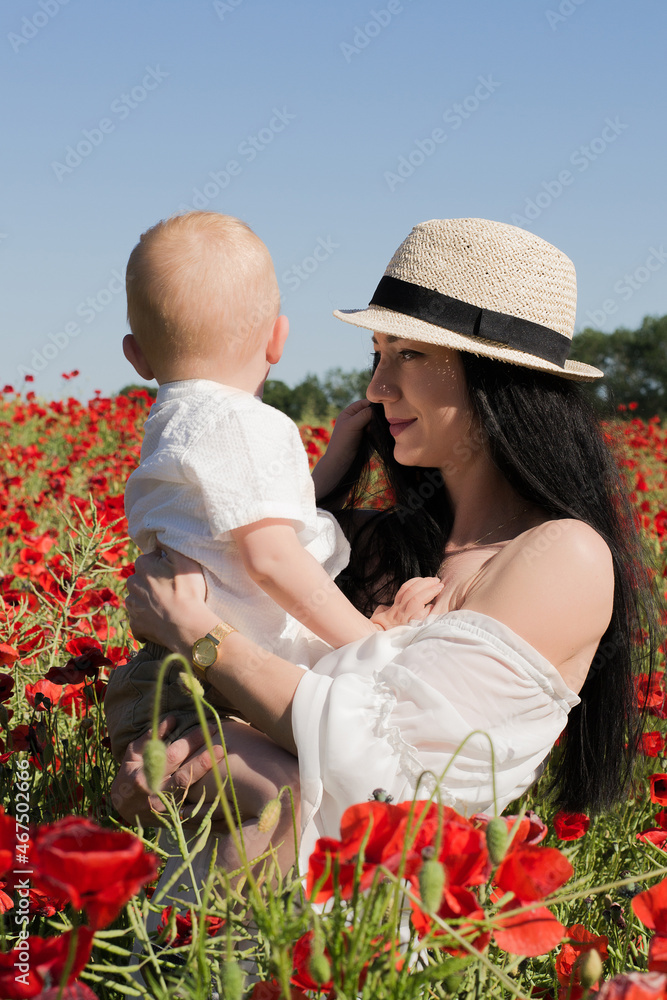 mother and son in the field of poppy