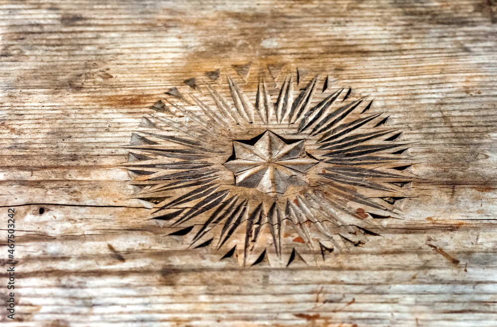 Carved pattern on an old stool close-up in summer Carved pattern on an old stool close-up in summer