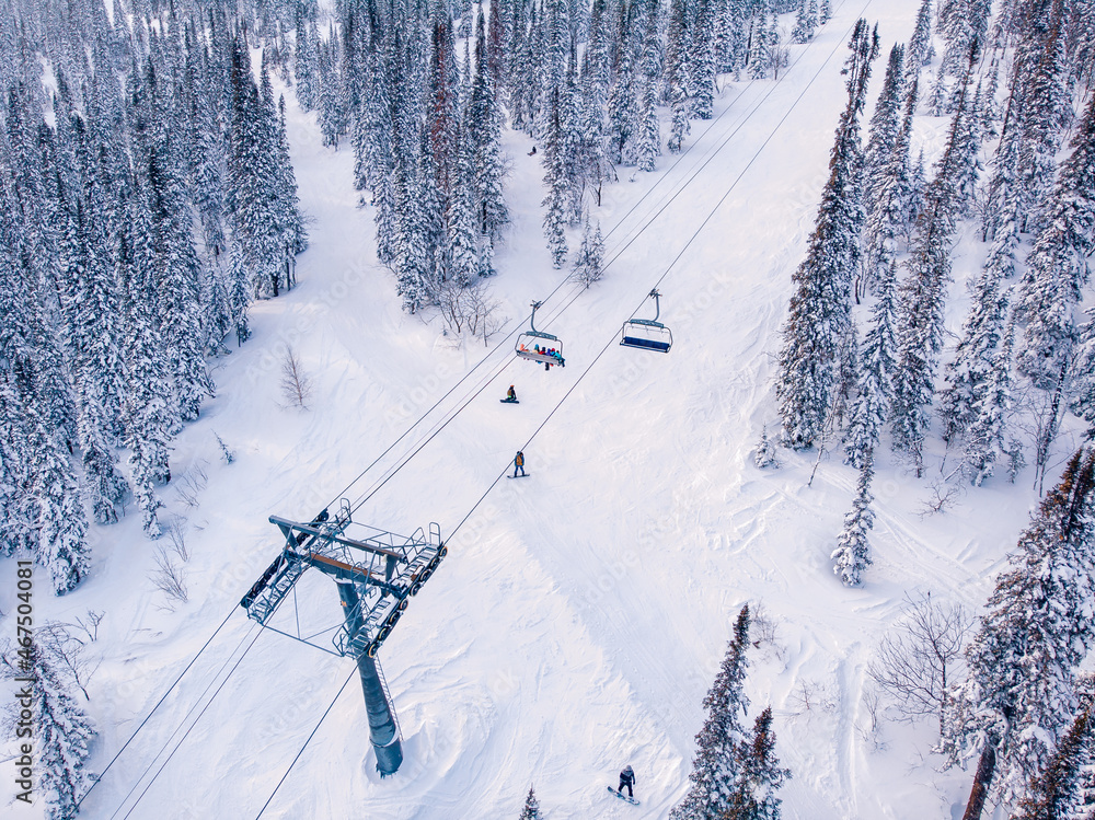 Ski lifts Winter mountains with snowy forest, aerial top view