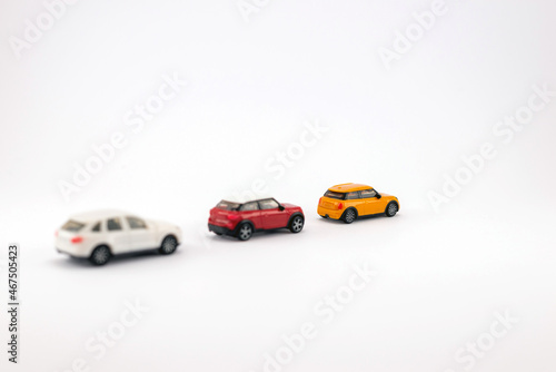 Three toy cars on white background