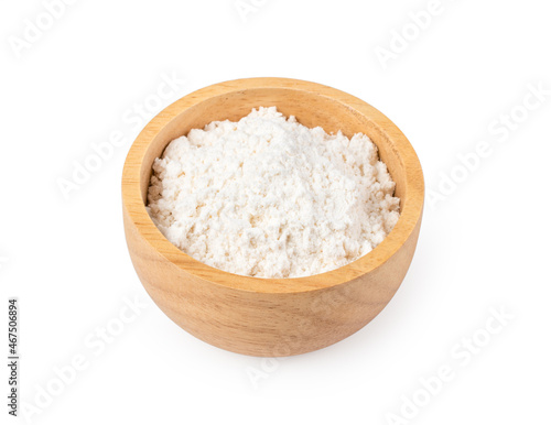 Milk powder in wooden bowl on white background.