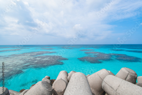 Tetrapods by the beautiful coral reef ocean of Hateruma island, Okinawa, Japan near Ishigaki island. Clear blue sea with coral visible. Blue sky and sunny day.  © Kaori