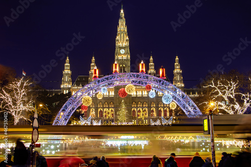 Photography The tram is ride in front of the Christmas market by City hall -  Rathaus in night Vienna, Austria