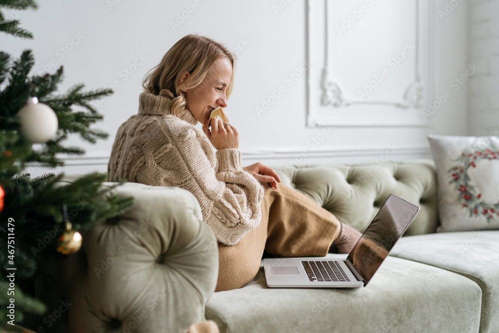 Woman using laptop at home. Cropped shot of female using laptop, using social media Woman using laptop at home. Cropped shot of female using laptop, using social media