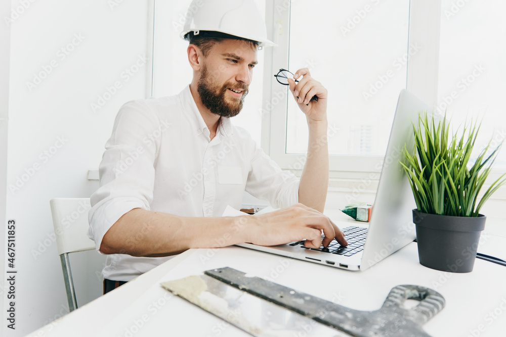 man in white helmet working table technology and professional man in white helmet working table technology and professional
