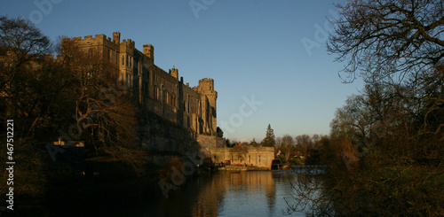 old British Castle in warwick westmidlands in golden autumn light with the blue sky background during autumn photo