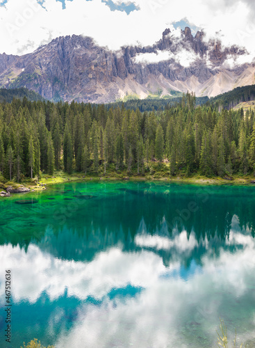 Small beautiful lake surrounded by mountains in Dolomite alps, Italy © Maresol