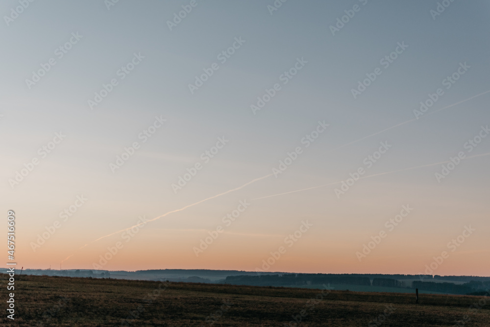 a soft sunset spreading over nature and the forest a soft sunset spreading over nature and the forest