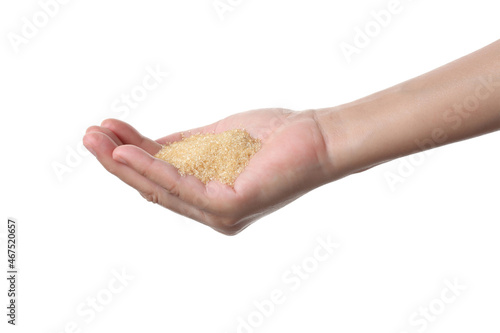 Hand holding brown sugar on white background