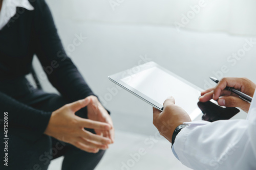 Εκτύπωση καμβά Psychiatrists hold tablets and advise patients at a psychologist session and explain how to fix the problem caused by stress related to economic problems after covid 19, Psychotherapy concept