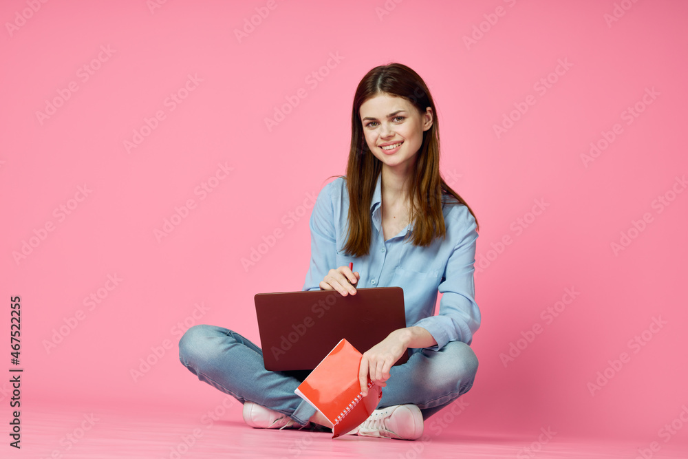 woman sitting on floor with laptop shopping entertainment pink background woman sitting on floor with laptop shopping entertainment pink background
