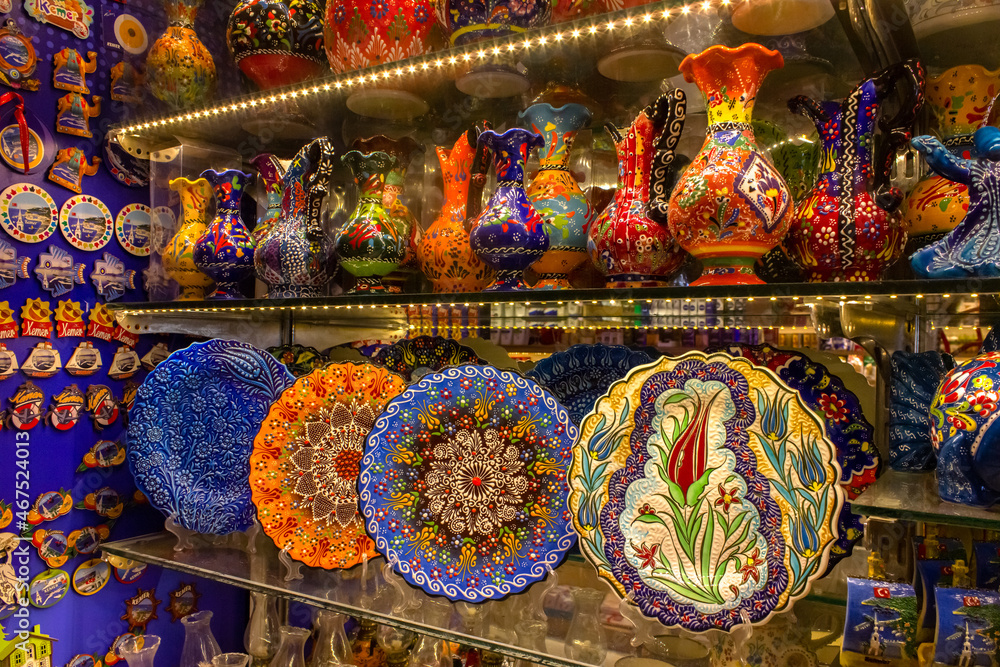 National patterns on ceramic dishes. Multicolored plates with traditional patterns are on the shelf