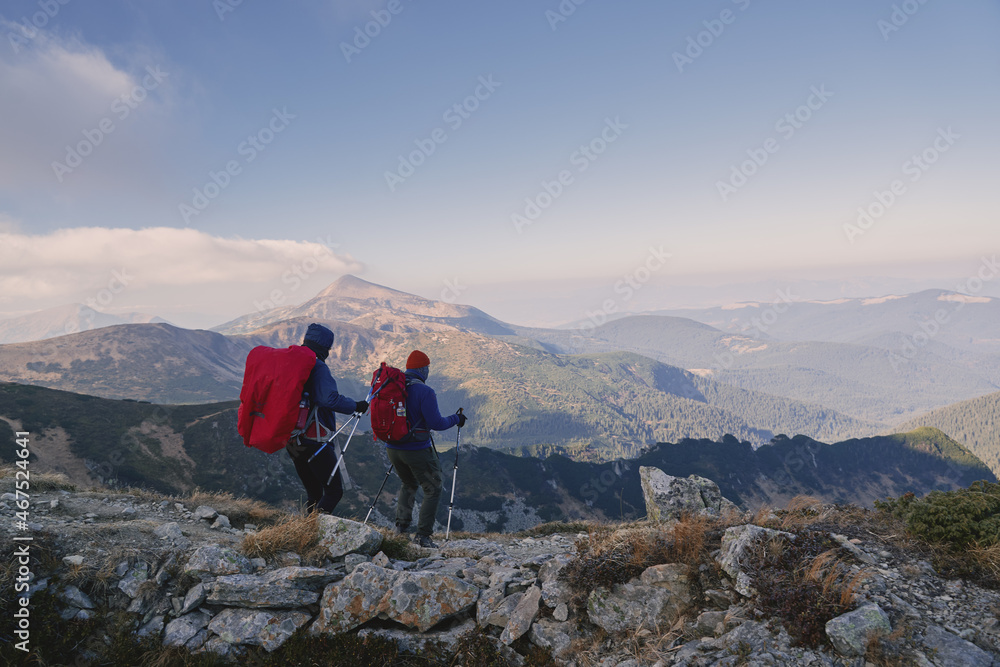 Fototapeta premium Tourists with backpacks at the top of the ridge. Ukrainian Carpathian mountains. Chornohora ridge.