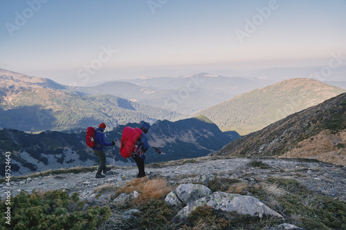 Tourists with backpacks at the top of the ridge. Ukrainian Carpathian mountains. Chornohora ridge. © Vitaly