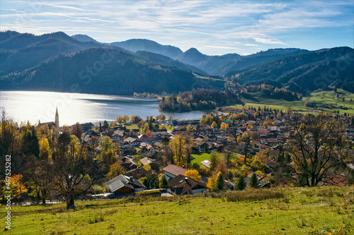 Panoramic view of Schliersee lake during Autumn with Alps as a background. Mountain lake Schliersee during Fall and a small city in german Alps, Bavaria, Germany © devnenski