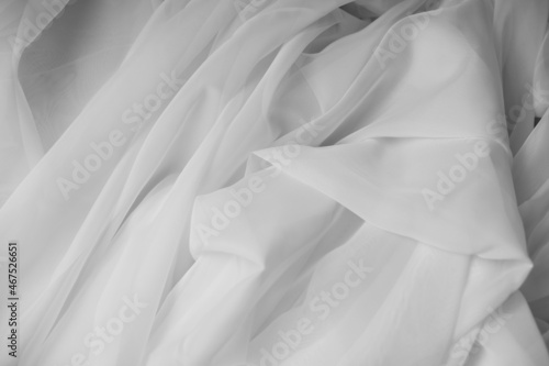 White fabric texture background. White tulle drapery.