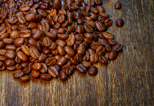 Roasted coffee beans on dark wooden background with copy space