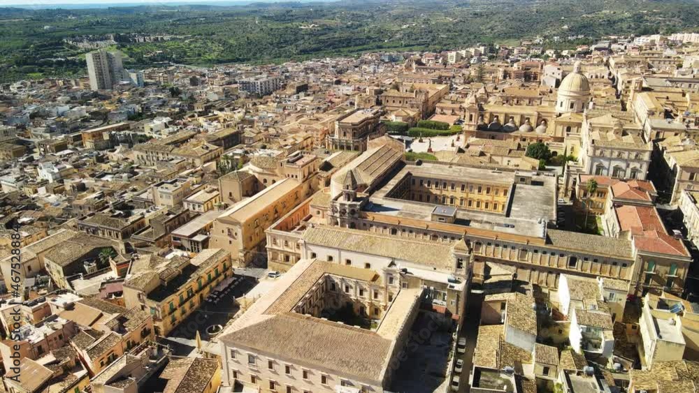 Aerial view of Cathedral of Noto (La Chiesa Madre di San Nicolò), UNESCO world heritage site and example of sicilian baroque. Drone flies above the Cathedral of Noto in the central street Aerial view of Cathedral of Noto (La Chiesa Madre di San Nicolò), UNESCO world heritage site and example of sicilian baroque. Drone flies above the Cathedral of Noto in the central street