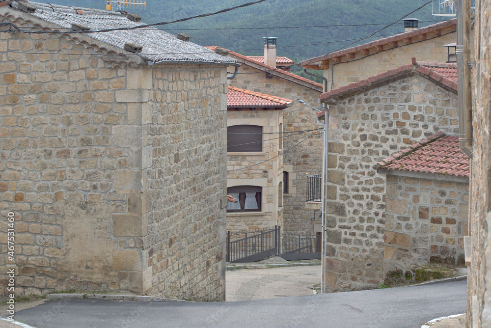 Street and architectural details of the houses. Village of Regumiel de la Sierra, province of Burgos, Spain.