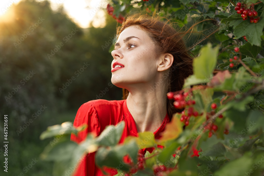 Naklejka premium pretty woman in red shirt nature green leaves summer