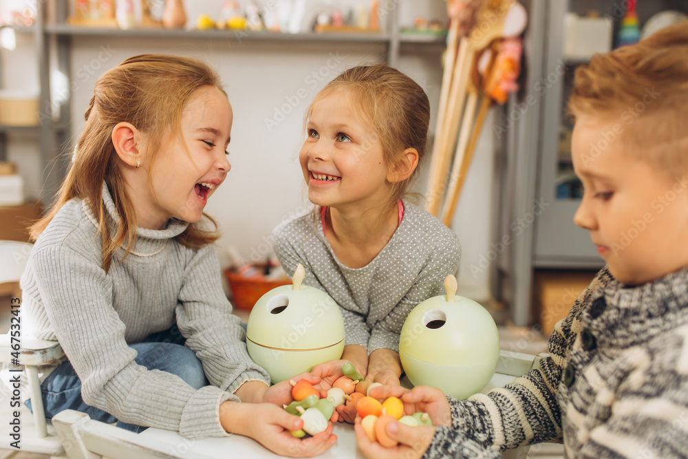 Happy smiling children playing together with wooden eco toys. Friendship,children activity Happy smiling children playing together with wooden eco toys. Friendship,children activity