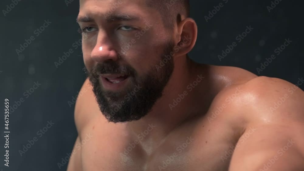 Muscular athletic young fitness man workout in the gym doing exercise bike cardio. Sport and health care concept 
