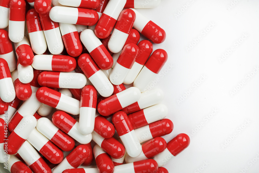 Red and white tablets on a white background with free space. Red and white tablets on a white background with free space.