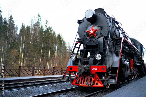 Republic of Karelia Russia - Soviet L-series steam locomotive with the Ruskealsky Express tourist train on the platform of the marble canyon railway station. photo