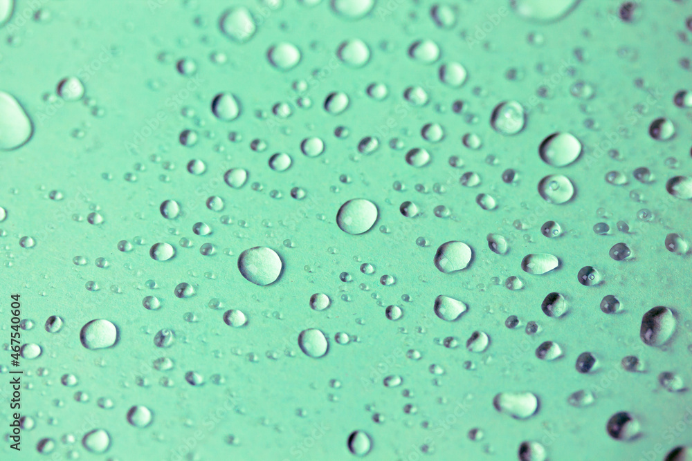 Lots of small oxygen bubbles under the water. Turquoise clear transparent liquid background and texture. Drops of water or rain on a green surface, natural abstract backdrop. Fresh mineral water. Lots of small oxygen bubbles under the water. Turquoise clear transparent liquid background and texture. Drops of water or rain on a green surface, natural abstract backdrop. Fresh mineral water.
