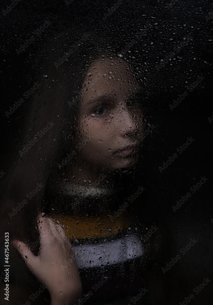 portrait of a girl with a reflection on a dark background by the window portrait of a girl with a reflection on a dark background by the window
