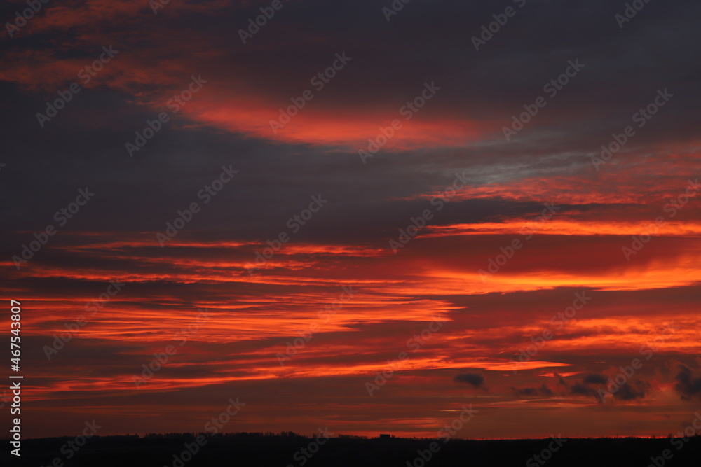 Fototapeta premium dramatic clouds in crimson color during sunrise