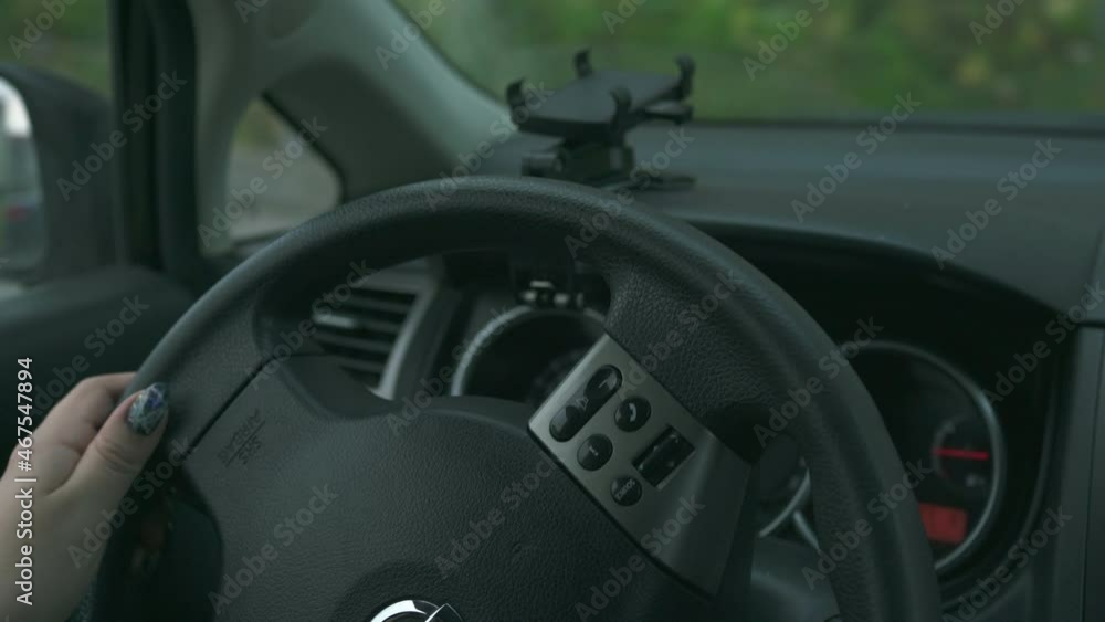 woman driver turns the steering wheel close up woman driver turns the steering wheel close up