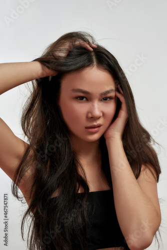 Portrait of young Asian woman flirting at camera