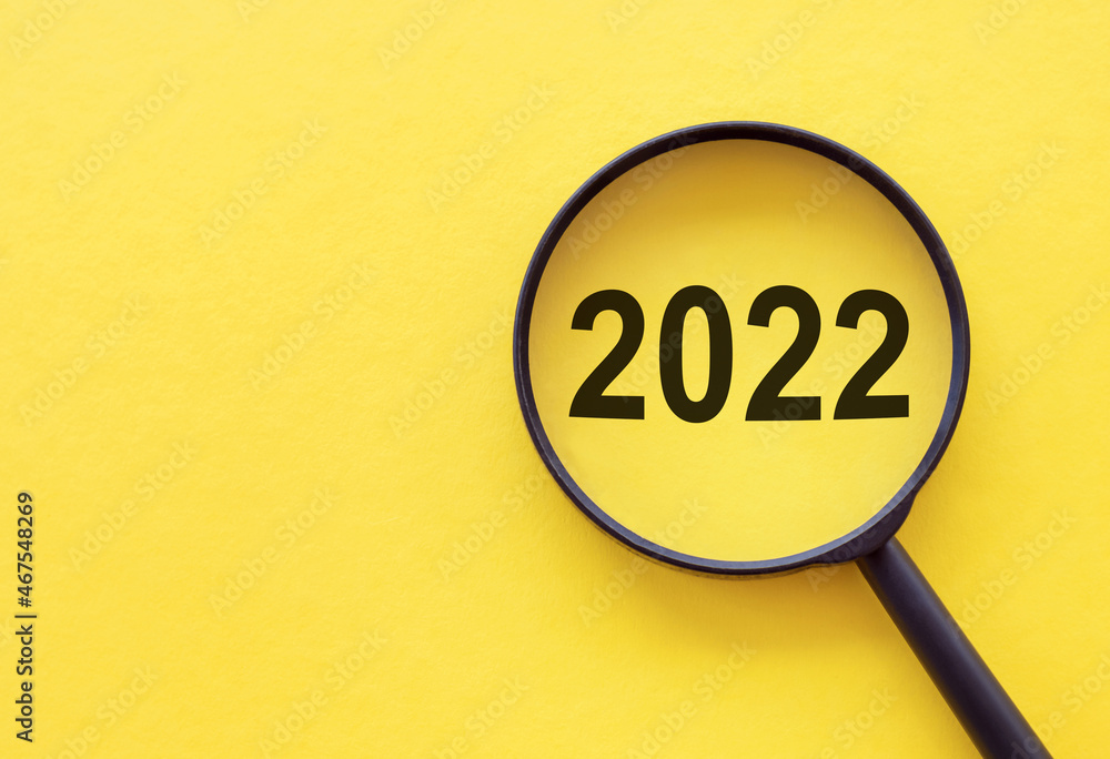Text 2022 and magnifying glass. Setting goals and objectives for the new year. Planning, business management and strategy concept. Trends and ideas. Vision. Text 2022 and magnifying glass. Setting goals and objectives for the new year. Planning, business management and strategy concept. Trends and ideas. Vision.