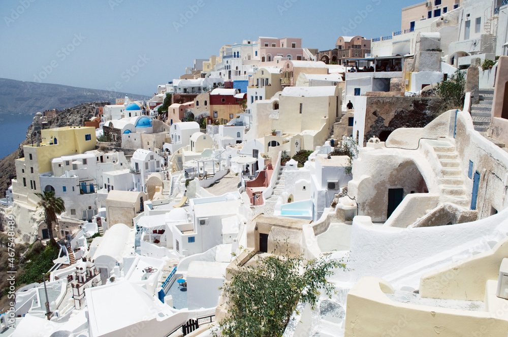 GREECE, SANTORINI: Scenic seaside landscape view of white classics buildings on the rocky slopes of Thira island  