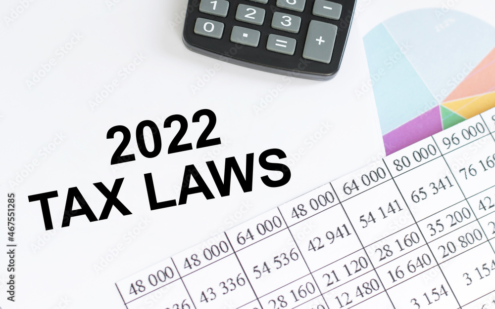 2022 Tax Laws. Conceptual background with chart, papers, calculator 2022 Tax Laws. Conceptual background with chart, papers, calculator