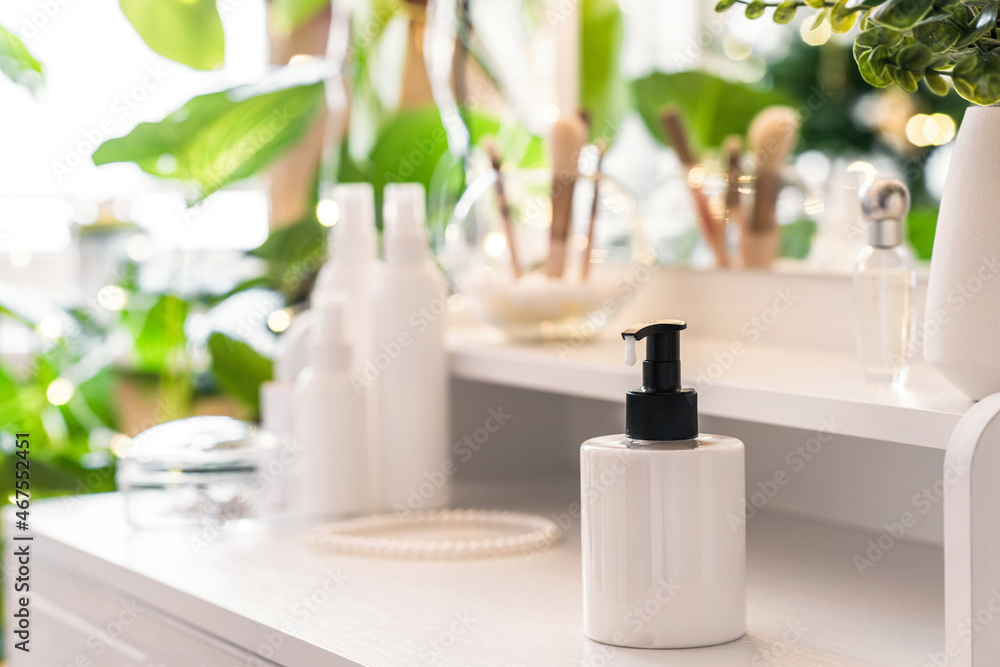 Woman daily cream on dressing table with make up accessories. Reflection of christmas tree, light bulbs in table mirror. Woman daily cream on dressing table with make up accessories. Reflection of christmas tree, light bulbs in table mirror.