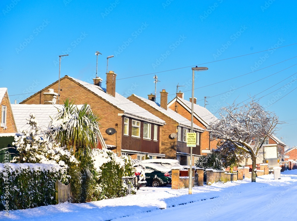 Street with two-storey houses, all in the snow. Street with two-storey houses, all in the snow.