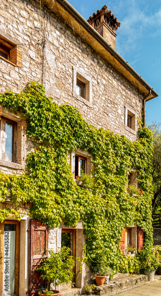 Fototapeta premium View on a stone house in the village of Cison Valmarino along the water way, Treviso - Italy