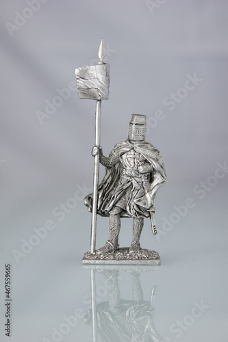 Tin soldiers of medieval knights. A knight with a banner. photo