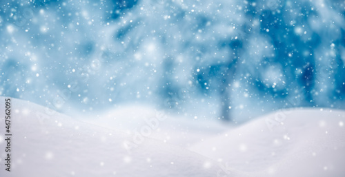Snowy background with closeup view of the wavy snowdrifts in snowfall. © candy1812