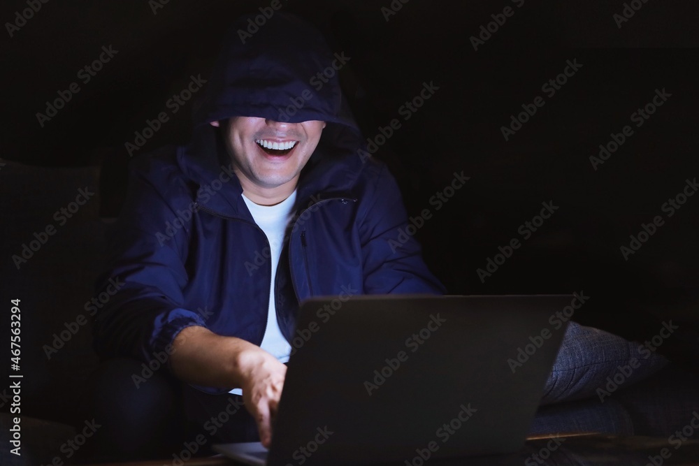 Hacker using laptop,he’s trying to hacking some data from server’s bank. Hacker using laptop,he’s trying to hacking some data from server’s bank.